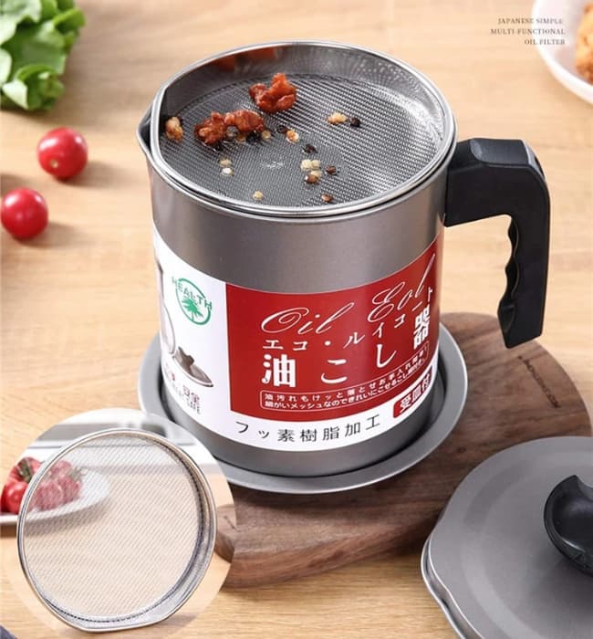 Carbon steel oil filter pot for storing and filtering used cooking oil.