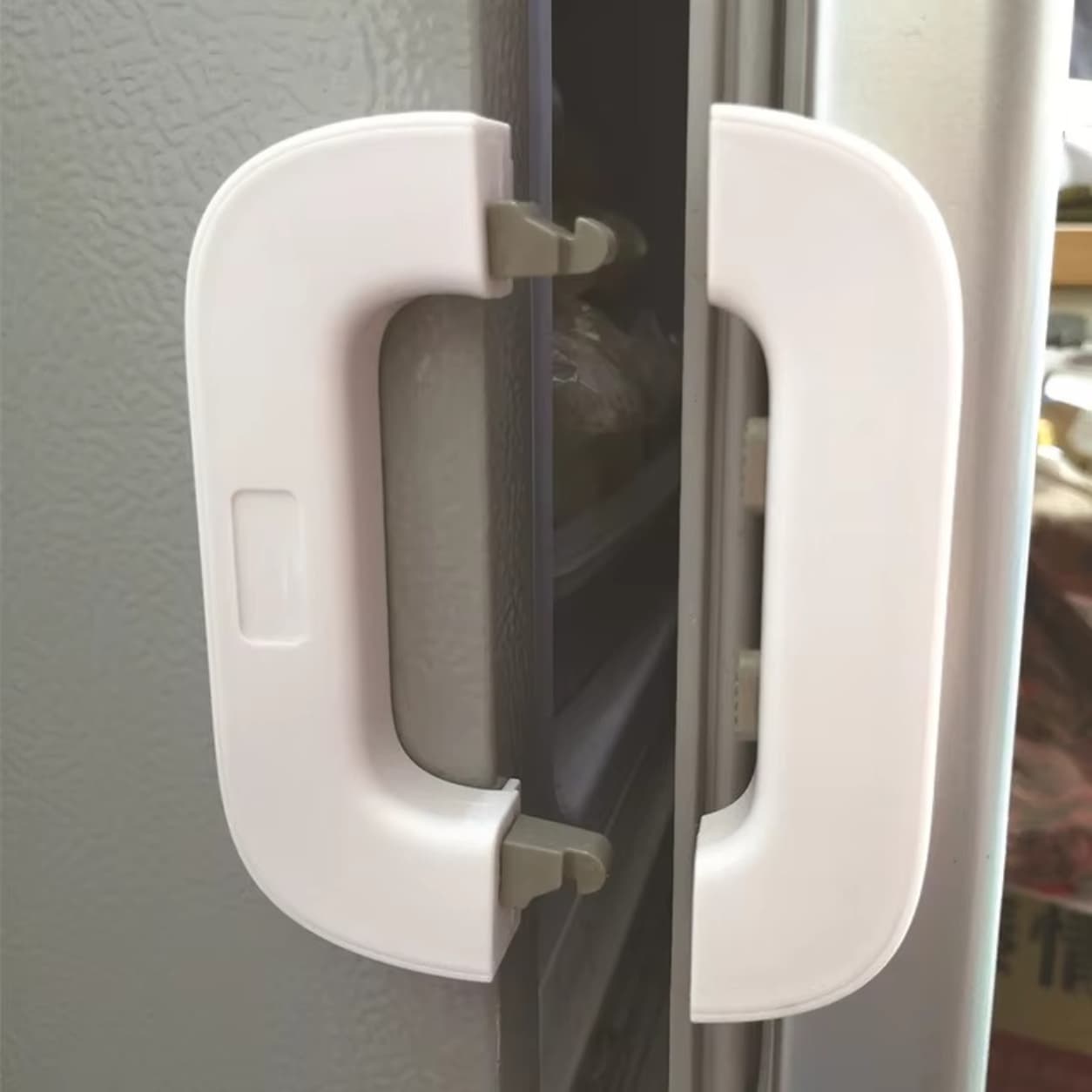 Child safety fridge lock for secure refrigerator door protection.