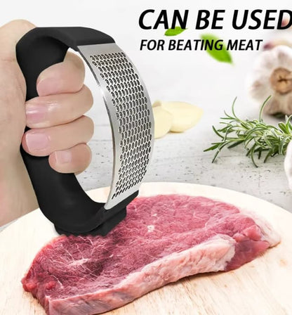 Handheld garlic press crusher for fresh cooking ingredients.