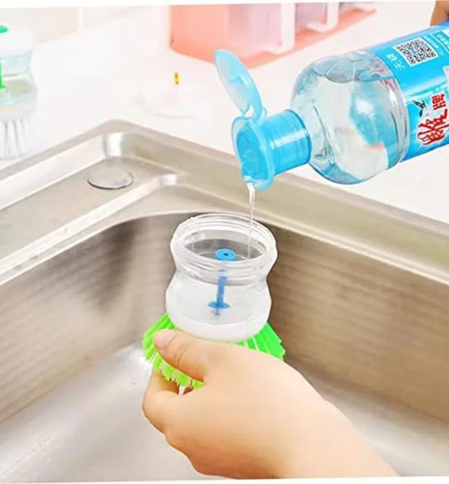 Kitchen dish scrubber brush with liquid soap dispenser for fast cleaning.