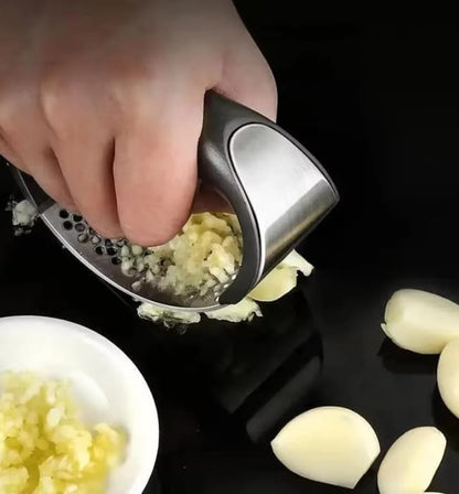Kitchen garlic crusher tool for quick and simple food preparation.