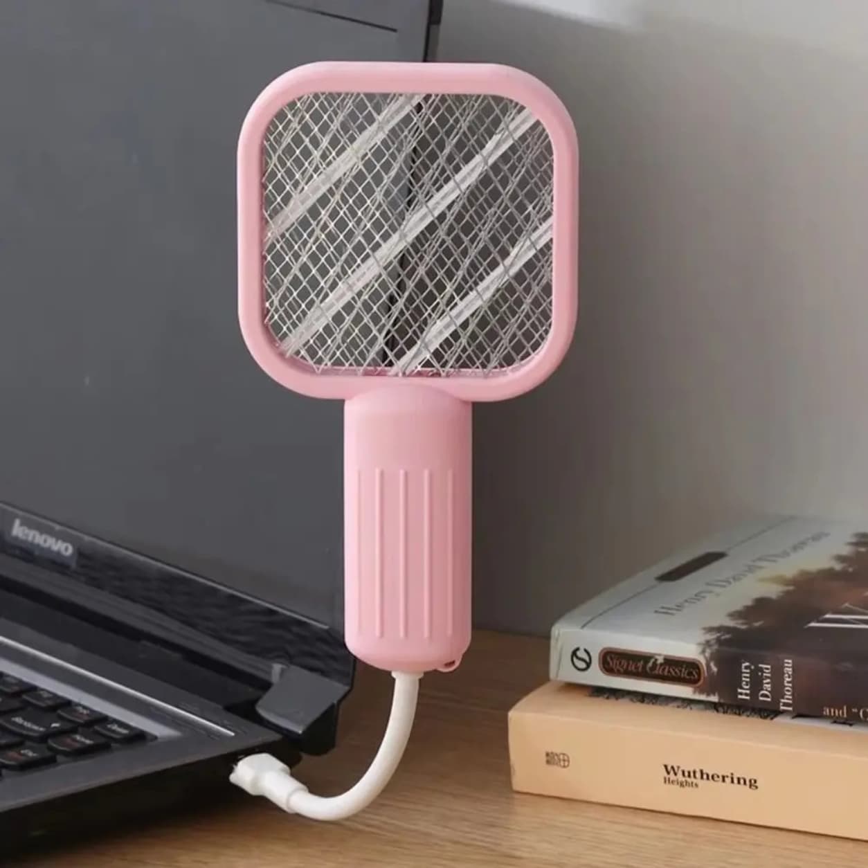 Portable bug zapper racket with rechargeable USB charging.