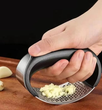 Manual stainless garlic press for easy crushing of garlic and ginger.