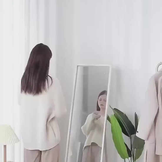 Electric lint remover in use removing fuzz and fabric pills from sweater