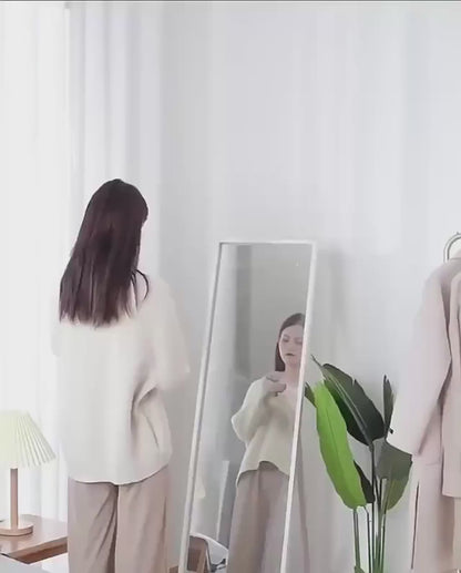 Electric lint remover in use removing fuzz and fabric pills from sweater